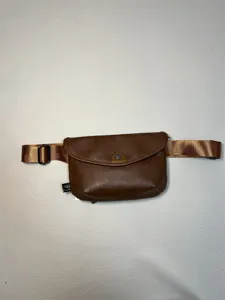 Brown leather fanny pack detail, vintage waist bag with adjustable wide strap for men.