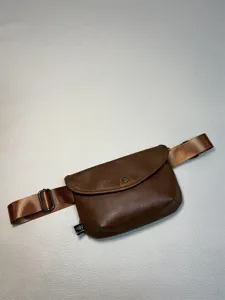 Brown men vintage sling bag detail view, casual PU leather chest pack with adjustable strap.