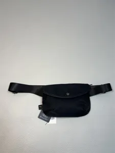 Black nylon waist bag for men, casual crossbody chest bag with adjustable strap and zip.