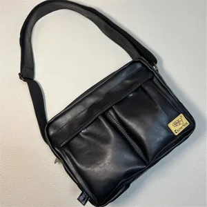 Black Japanese style PU leather messenger bag with adjustable strap and dual front pockets.