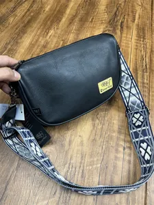 Detail shot of the black crescent crossbody bag with patterned wide strap, casual Korean style.