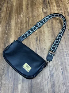 Casual black crossbody shoulder bag with patterned wide strap and front logo patch.
