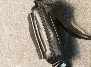 Detailed close-up of a black casual PU leather men's crossbody shoulder bag zipper view.