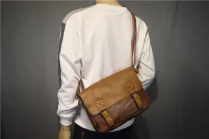 Detailed view of brown vintage messenger bag showing dual buckle straps and textured leather finish.