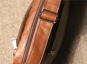 Detail view of brown retro men shoulder bag featuring metallic zippers and adjustable strap buckle.