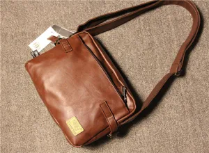 Close-up detail of the vintage brown PU leather messenger bag showing adjustable strap.
