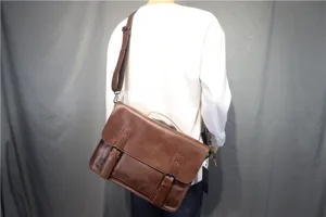 Brown leather vintage messenger bag detail view, casual business crossbody bag with buckles.