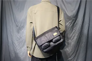 Detail view of vintage leather messenger bag for men, showcasing flip cover and dual front pockets.