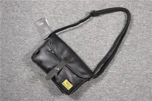 Men's casual retro black PU leather messenger bag with magnetic buckle and crossbody strap.