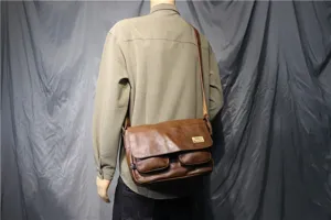 Brown leather messenger bag detail view, casual crossbody satchel with double front pockets.