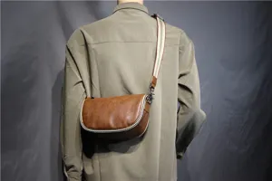 Men brown leather saddle bag detail, vintage crossbody bag with stylish striped canvas strap.