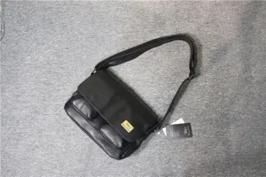 Black leather messenger bag detail, retro style casual crossbody bag with flap and dual pockets.