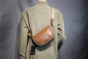 Close-up detail view of vintage brown leather men saddle bag featuring a stylish striped strap.
