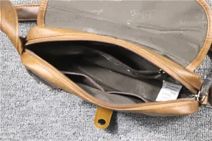 Detail view of the vintage brown men's casual crossbody bag interior structure and pockets.