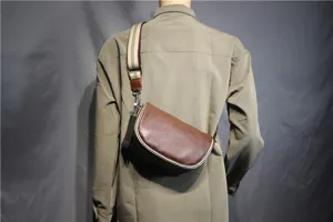 Men's retro brown leather saddle bag with striped canvas strap, stylish crossbody style.