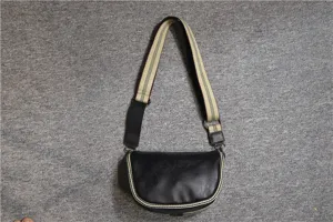 Men retro saddle bag with wide striped canvas strap, black leather crescent crossbody bag detail.