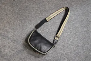 Black leather saddle bag detail, casual crossbody messenger bag with striped wide strap.