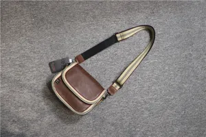 Brown leather crossbody bag with striped strap, casual stylish shoulder bag for daily use.