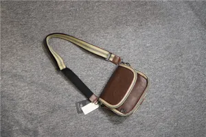 Casual brown leather crossbody bag with striped strap, stylish shoulder bag for daily use.