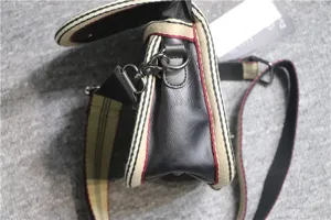 Side detail view of casual crossbody messenger bag with striped webbing and metal hardware.