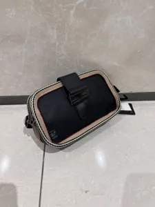 Retro striped crossbody bag featuring black leather, contrast web trim and secure metal buckle.