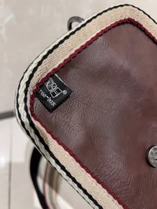 Detailed view of retro striped crossbody bag, premium leather texture, durable daily shoulder bag.