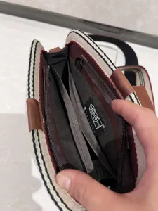 Interior structural details showing multi-compartment design of the vintage striped bag.