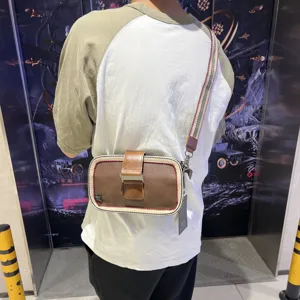 Vintage men's canvas crossbody bag with striped strap and leather buckle design stylish.