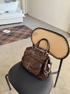 Retro oil wax leather biker style handbag with metal buckles and multiple pockets for women.