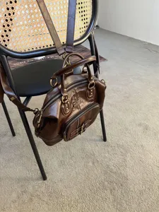 Vintage oil wax leather multi-way backpack and shoulder bag with metal hardware details.
