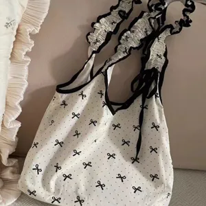 Sweet bow polka dot canvas shoulder bag for women, ruffled strap casual hobo tote handbag.