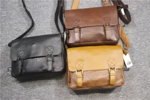 Detailed shot of vintage PU leather messenger bag showcasing texture, buckles and multi-color.