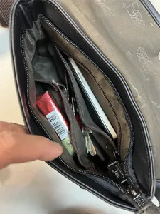 Men's casual crossbody bag interior structure detail, showing multi-pocket storage space.