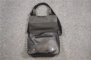 Black PU leather messenger bag detail showing flap closure, zipper pocket and adjustable strap.