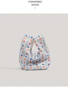 Primer plano de lindo bolso mini de lona floral con rayas azules y detalles de lazo.
