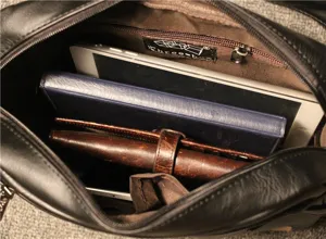 Interior detail of black leather messenger bag showcasing ample capacity for daily essentials.