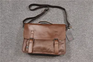 Detailed view of the brown vintage leather messenger bag featuring secure metal buckles and strap.