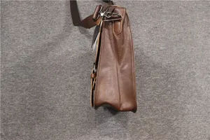 Brown leather messenger bag side detail view showing durable quality hardware and strap.