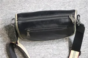 Men's black leather saddle bag multi-zipper detail view showcasing functional design.