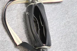 Men's black casual cross-body bag with multiple interior zipper pockets and adjustable strap.