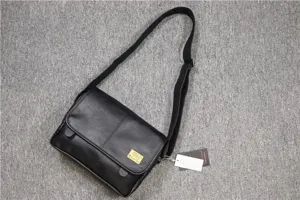 Three-box casual black leather messenger bag, fashionable horizontal crossbody style for men and women.