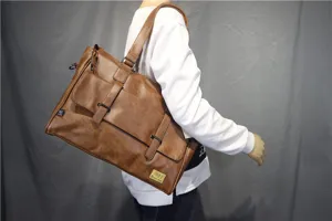 Men large PU leather shoulder messenger bag detail view with double buckle design for business travel.