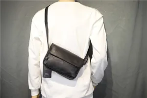 Detailed shot of black leather retro messenger bag worn by model, showing casual style.