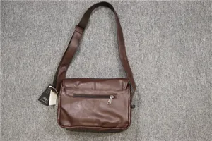 Brown leather shoulder bag detail, adjustable strap, casual design, zipper pocket.