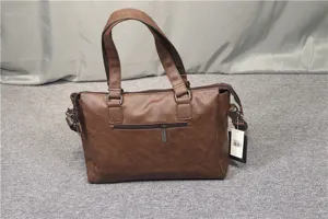 Detailed view of the brown leather business shoulder bag, showing the zipper and handle craftsmanship.