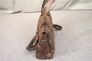 Detailed side view of brown men's business briefcase, leather messenger bag with multiple pockets.