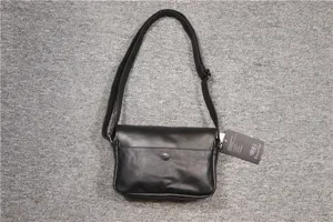 Black leather vintage crossbody shoulder bag for men and women, classic retro design.