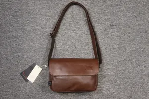Vintage brown leather messenger bag detail, casual shoulder crossbody bag with flap and strap.