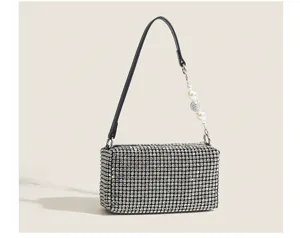 Close-up detail of the sparkling rhinestone evening bag with elegant pearl beaded strap.