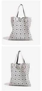 Detailed close-up view of the white geometric lattice tote bag showing its unique triangle pattern.